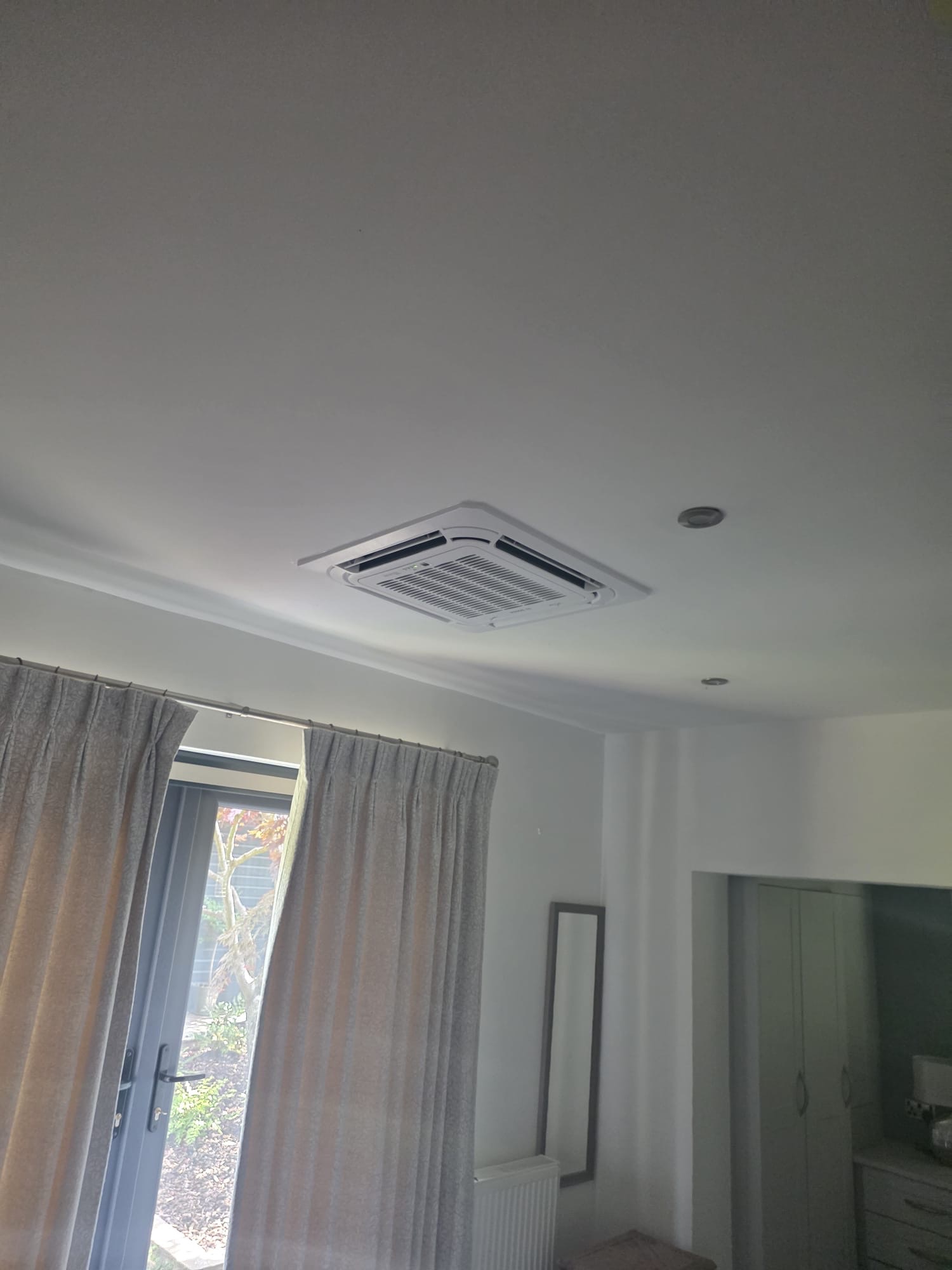 Ceiling cassette air conditioning unit in a bungalow bedroom in Hurstpierpoint