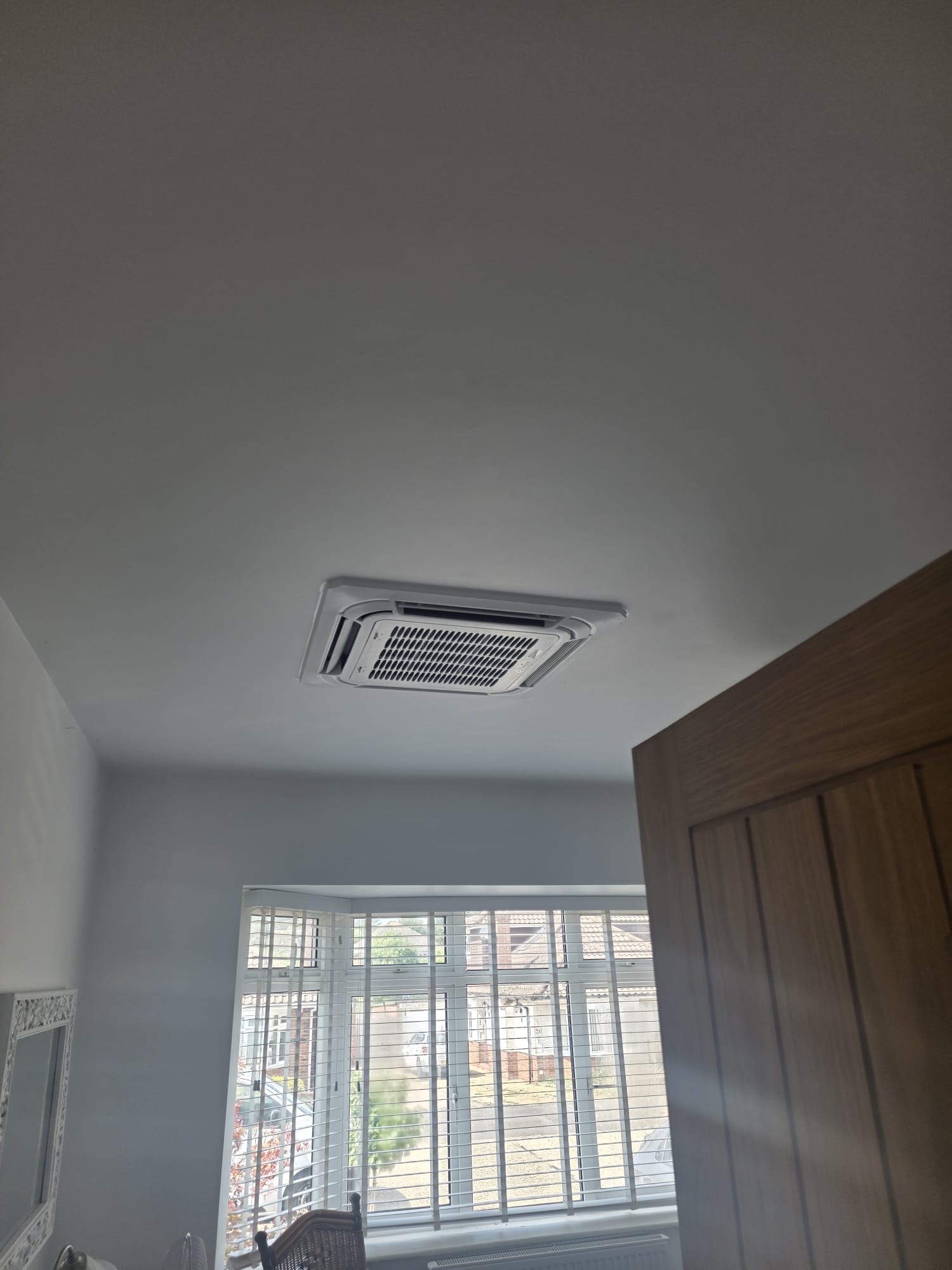 Four-way ceiling cassette fitted flush into a bedroom ceiling in Hurstpierpoint