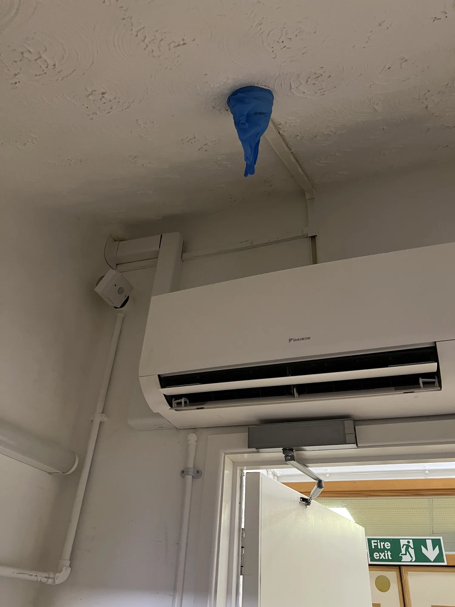 Outdoor condenser bracketed cleanly to the wall on a domestic split install